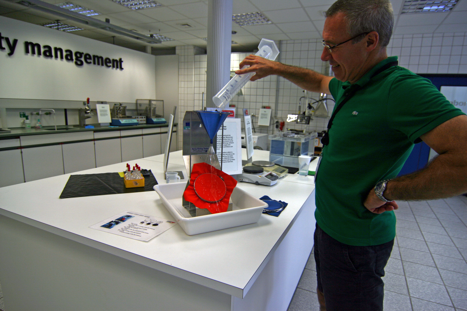 Beim Spraytest &uuml;berpr&uuml;ft Sander Effring die wasserabweisende Ausr&uuml;stung einer Stoffprobe. Auch wenn die Funktionalit&auml;t der Gore-Tex-Laminate durch die DWR-Ausr&uuml;stung nicht beeinflusst wird, muss diese einwandrei in Schuss sein. | Foto: Judith Hackinger