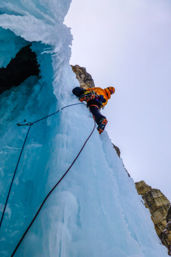 Eine Person beim Eisklettern.